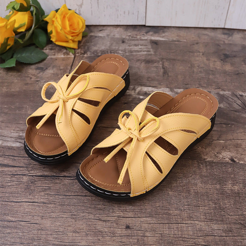 Hollow-out Bow Flat Wedge Slippers